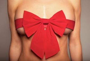 woman-with-red-bow-around-breasts
