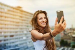 girl takes selfie on rooftop